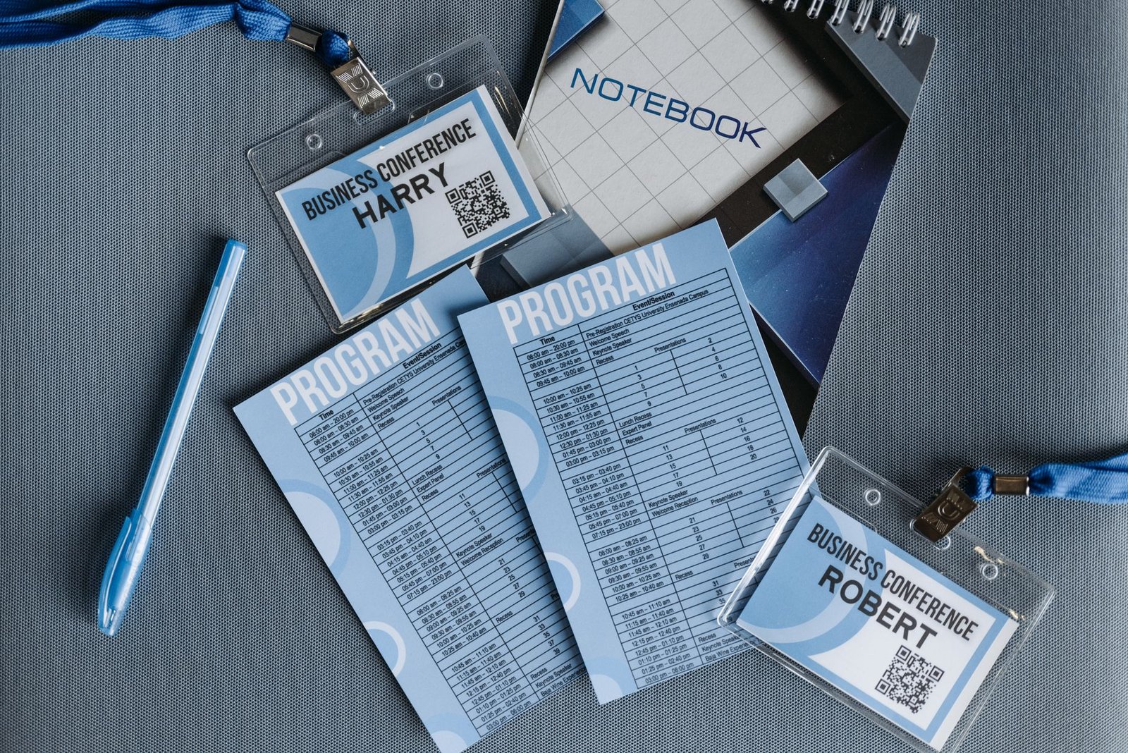 flat lay of speaker media kit materials including programs notebook and conference documents
