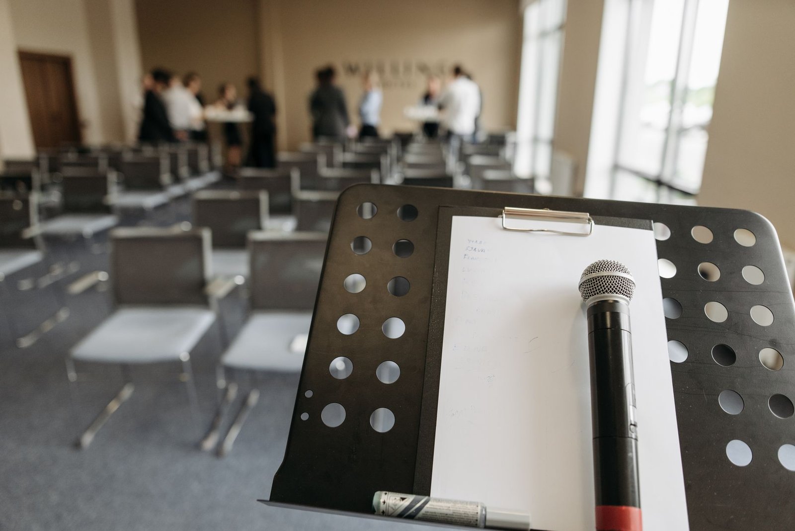 microphone on stand in conference room representing speaker media kit technical requirements