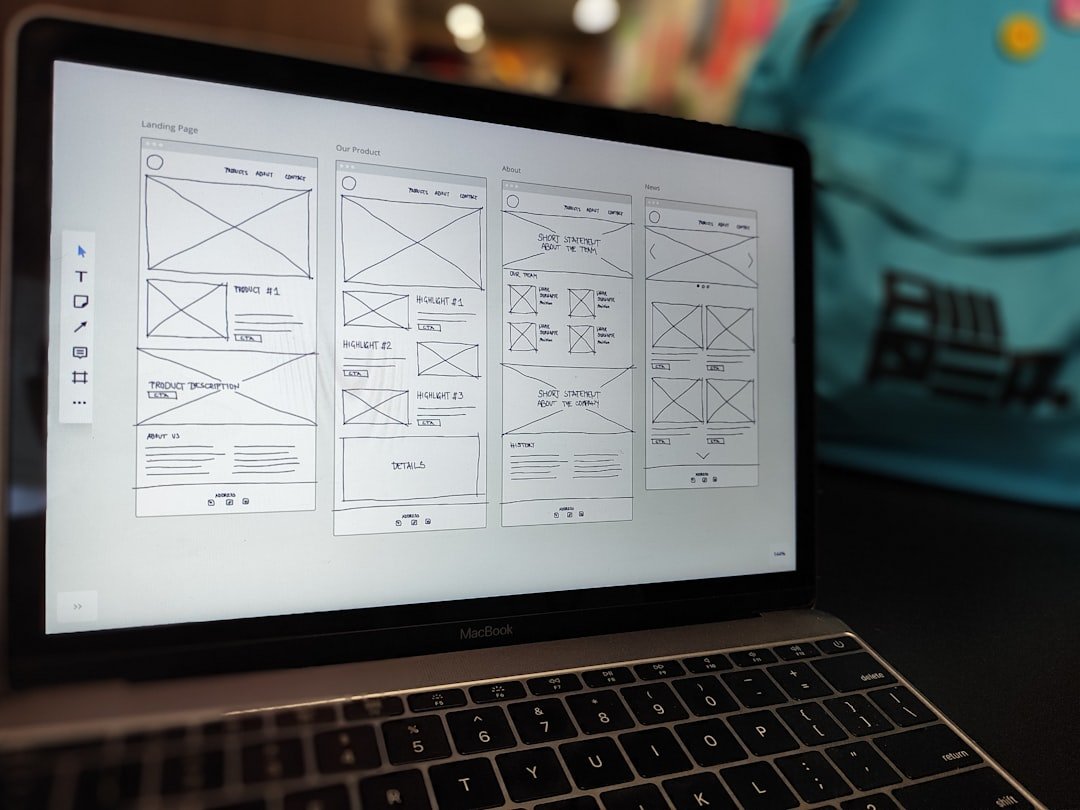 website wireframe on a MacBook screen showing speaker website design review