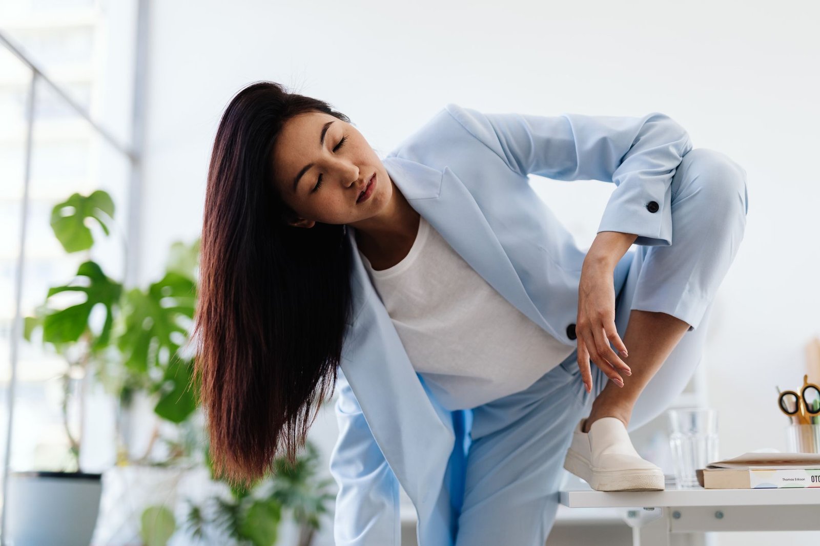 confident Asian woman in blue suit representing a coach repositioning herself as a keynote speaker ready for paid stages