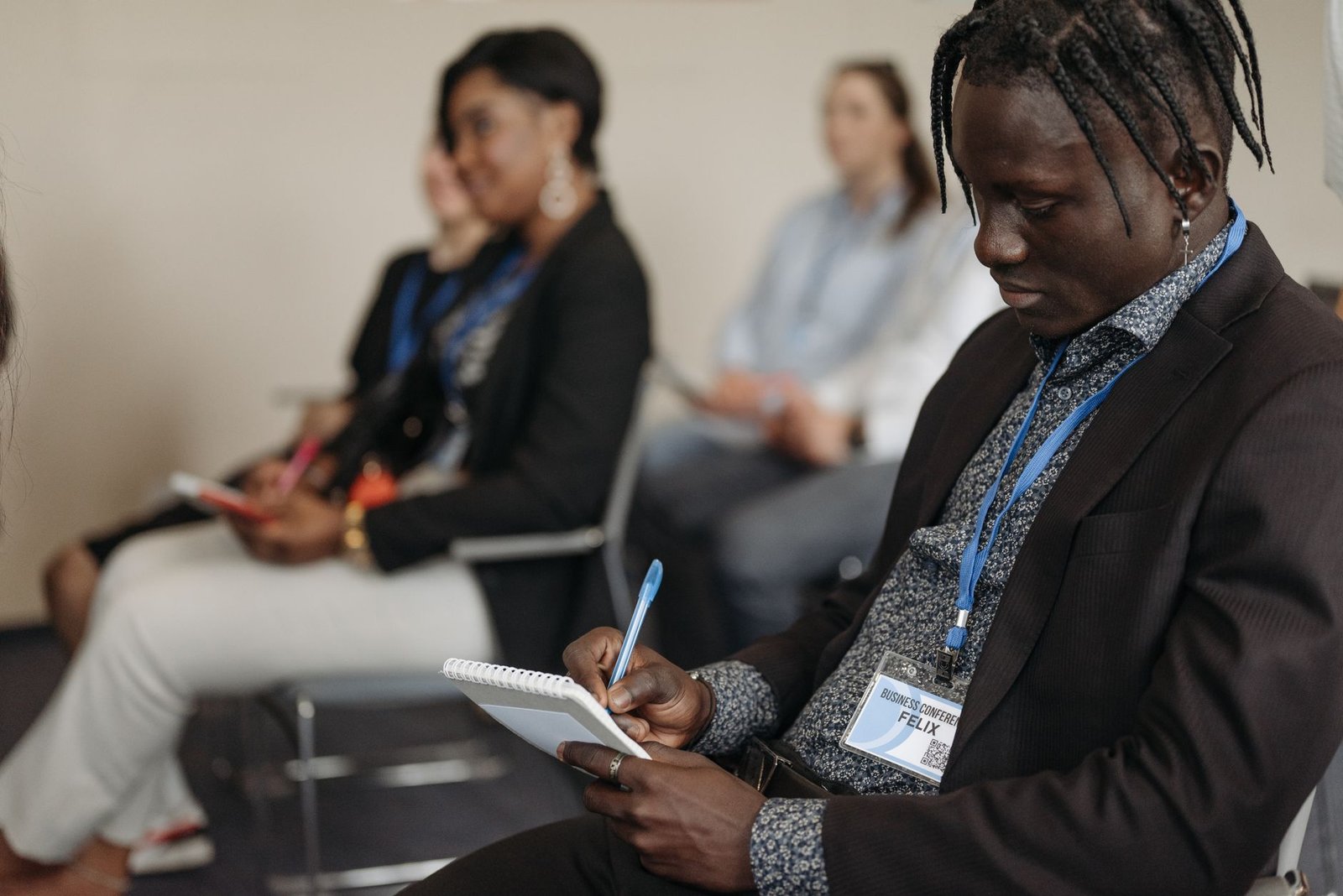 engaged audience taking notes at a business workshop representing the concrete outcome a keynote topic page promises organizers