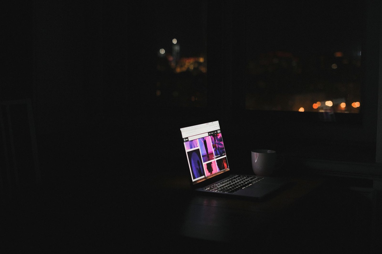 laptop glowing in a dark room at night representing a keynote speaker blog generating visibility around the clock