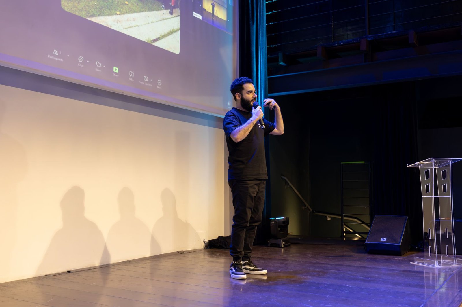 energetic speaker delivering a talk at a corporate event representing the outcome of investing properly in a speaking business