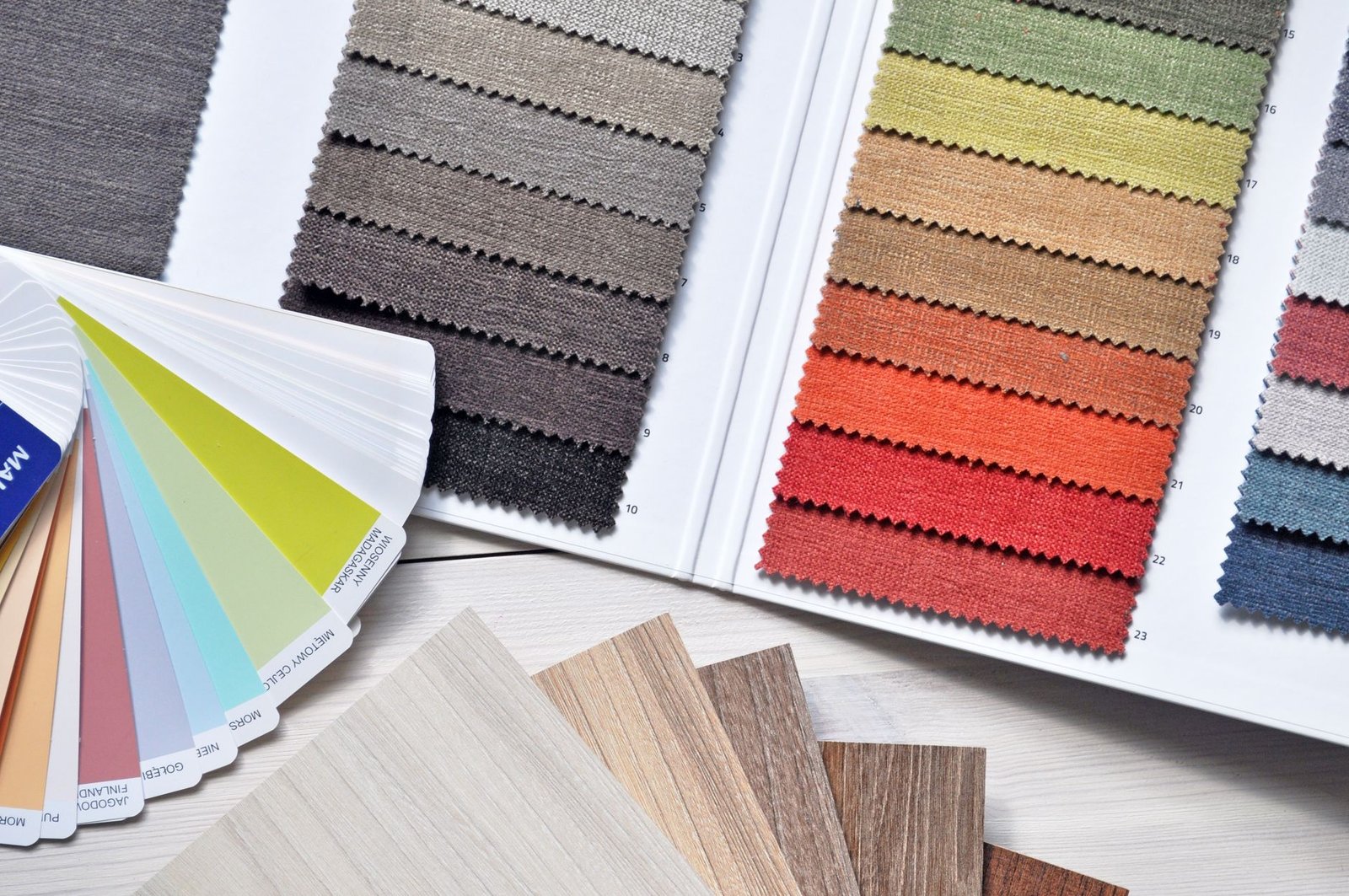 colorful fabric and paint swatches laid out representing the color and visual hierarchy decisions in a speaker homepage design