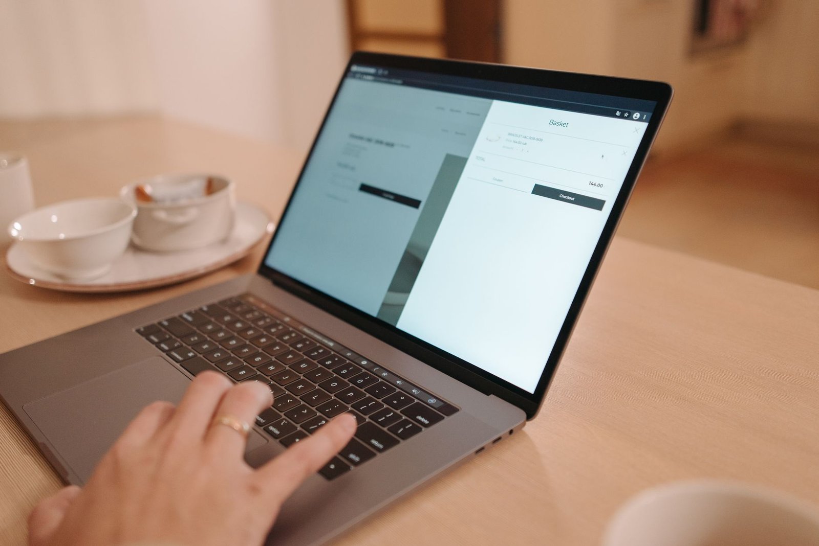 person using a laptop displaying a clean website representing the speaker's own domain where their writing should compound over time