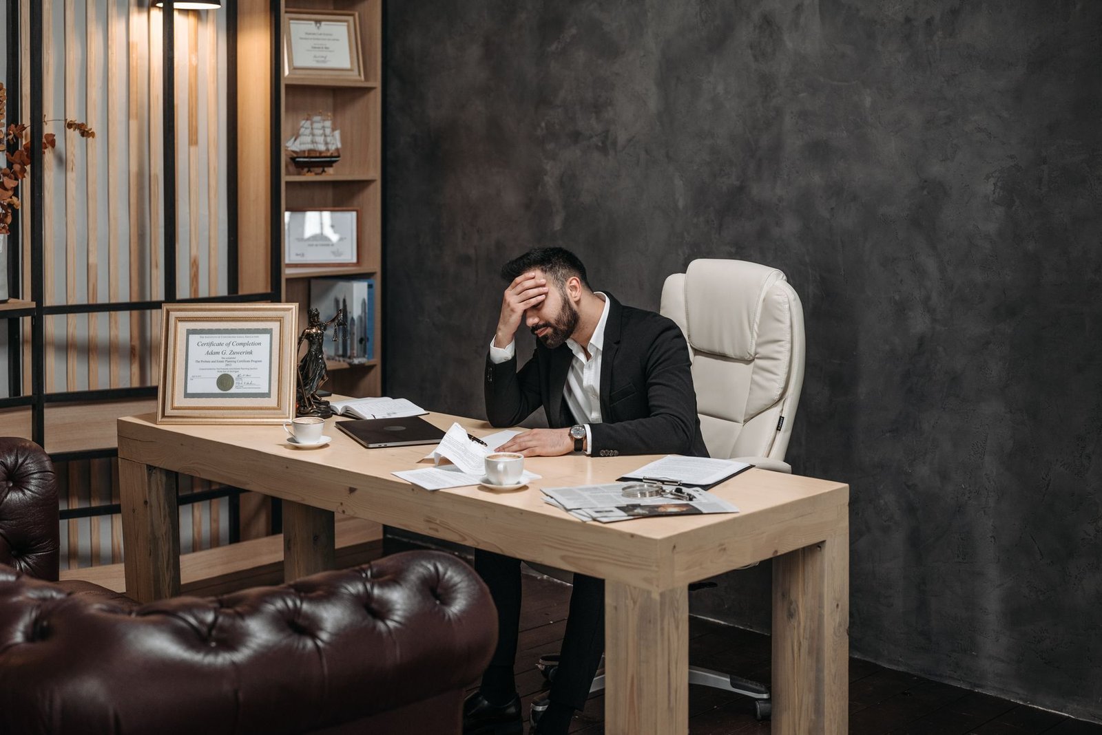 concerned businessman at office desk representing a keynote speaker whose outdated website is quietly costing bookings