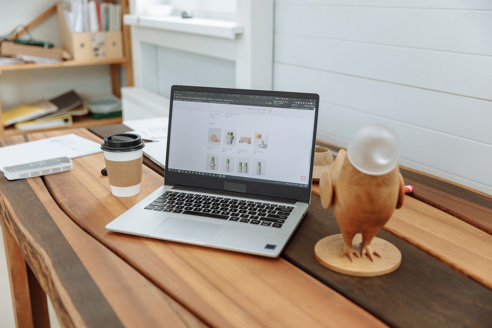 modern desk setup with laptop displaying a clean website representing the owned asset a speaker fully controls